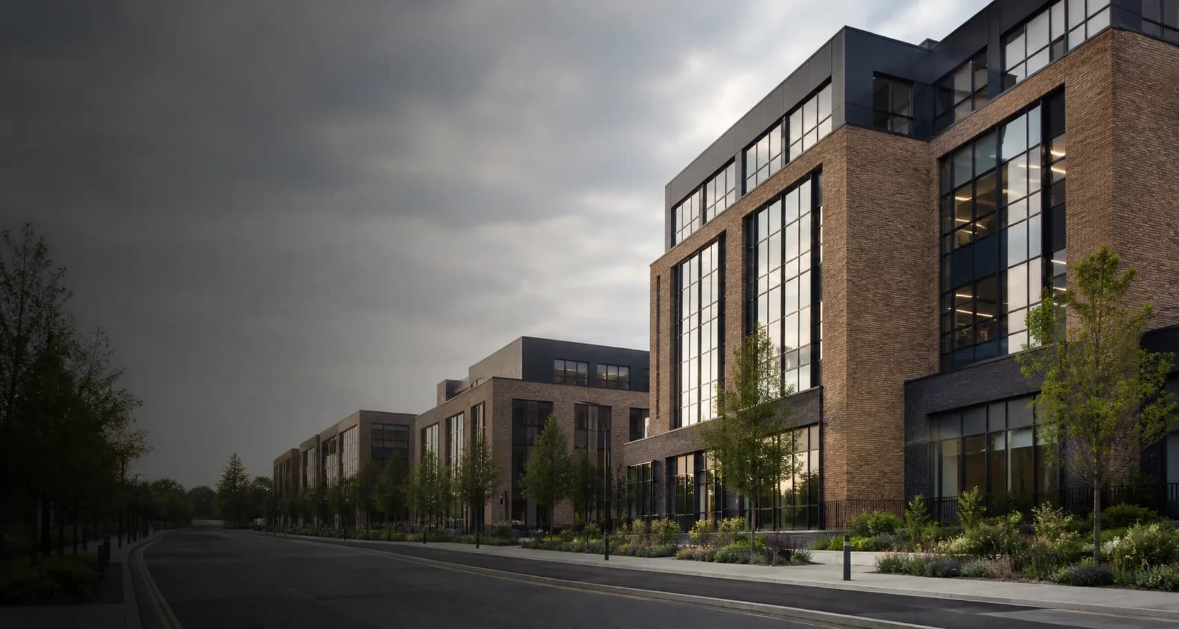 Contemporary commercial buildings in a landscaped UK urban setting; illustrative image only